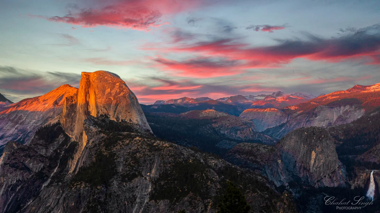Half Dome glowing pink at sunset, seen from Glacier Point in Yosemite.