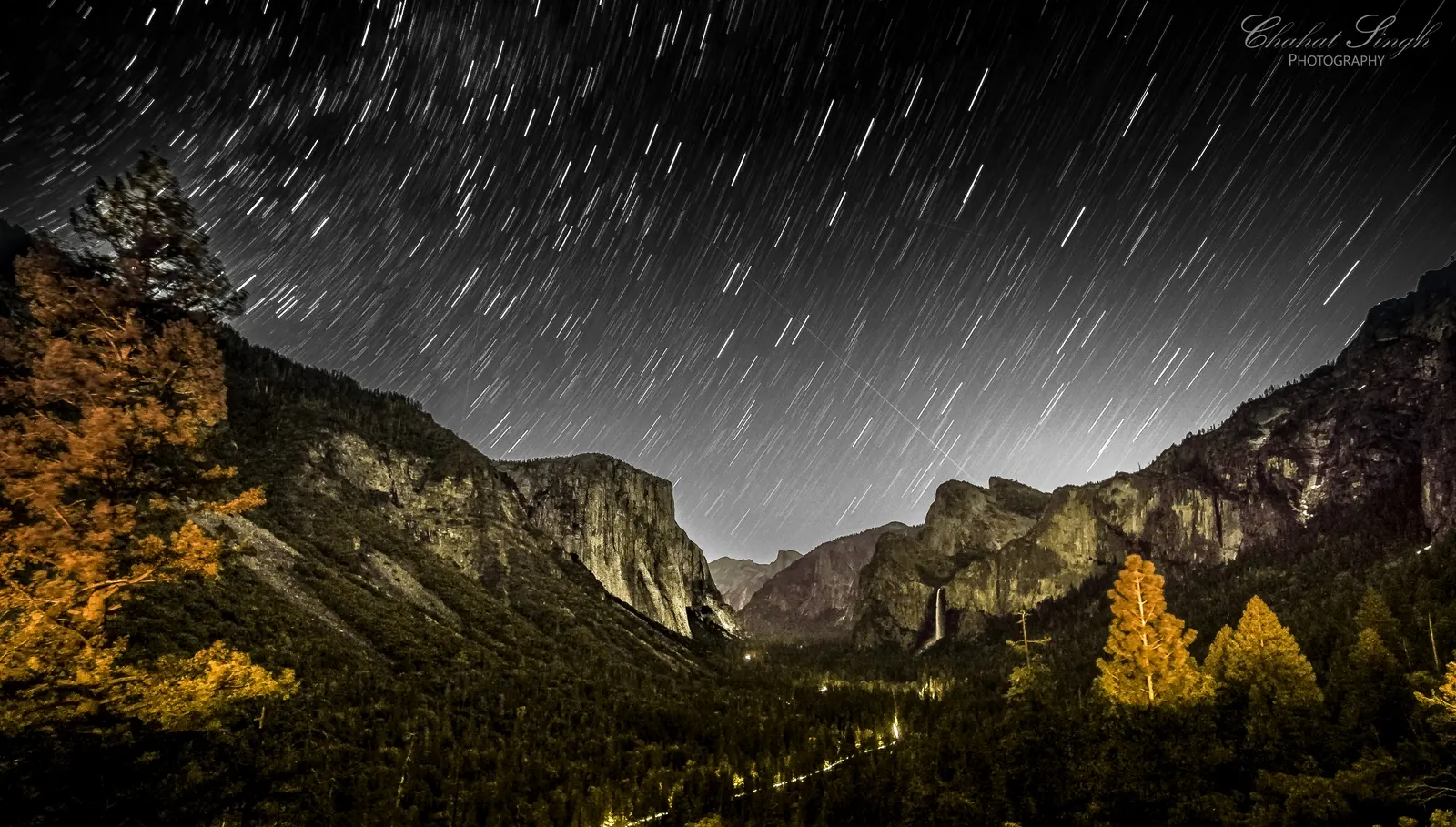 Circular star trails over Yosemite Valley, El Capitan and Half Dome silhouetted below.